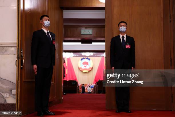 Security personnel stand outside the Great Hall of the People ahead of the opening of the second session of the 14th Chinese People's Political...