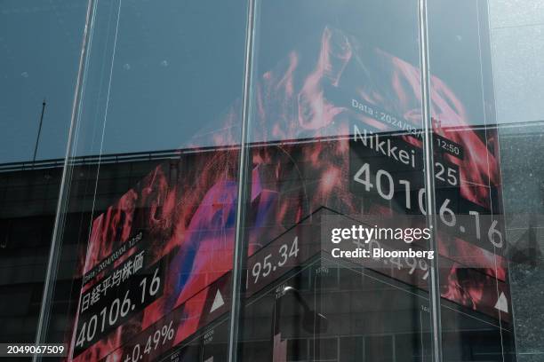 An electronic stock board showing the Nikkei 225 Stock Average inside a securities firm in Tokyo, Japan, on Monday, March 4, 2024. Japan's Nikkei 225...