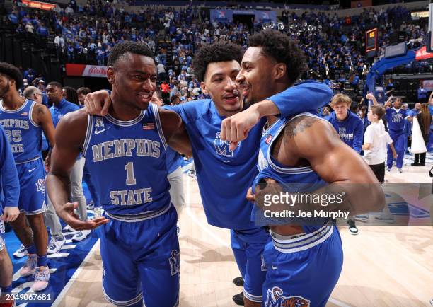 Jayhlon Young, Jahvon Quinerly and Joe Cooper of the Memphis Tigers celebrate against the UAB Blazers during the second half on March 3, 2024 at...