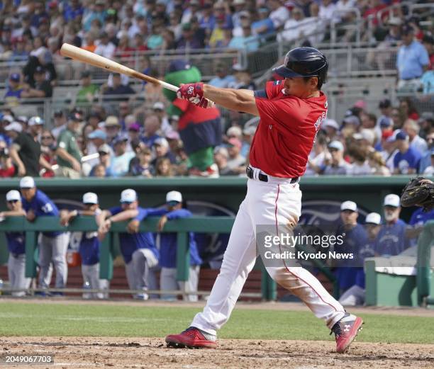 Masataka Yoshida of the Boston Red Sox hits an RBI single in the sixth inning of a spring training baseball game against the Toronto Blue Jays in...