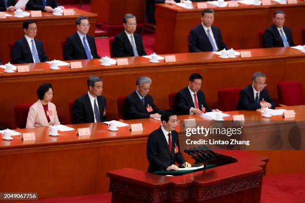 Wang Huning, a member of the Standing Committee of the Political Bureau of the Communist Party of China CPC Central Committee delivers his report...