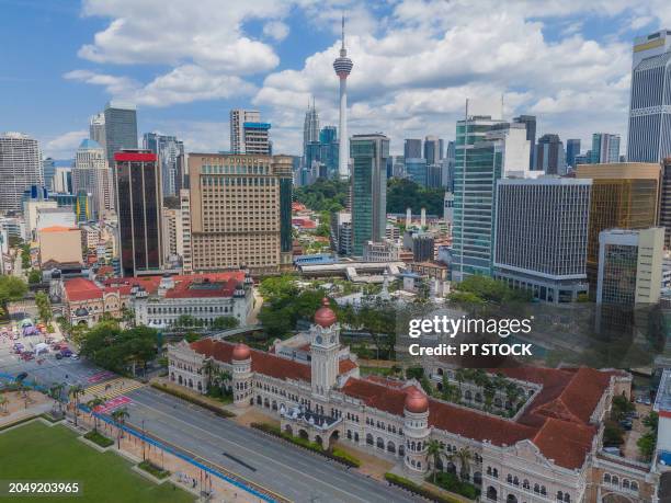 aerial view drone many tourists visit merdeka square and sultan abdul samad building, kuala lumpur, malaysia. - abdul stock pictures, royalty-free photos & images