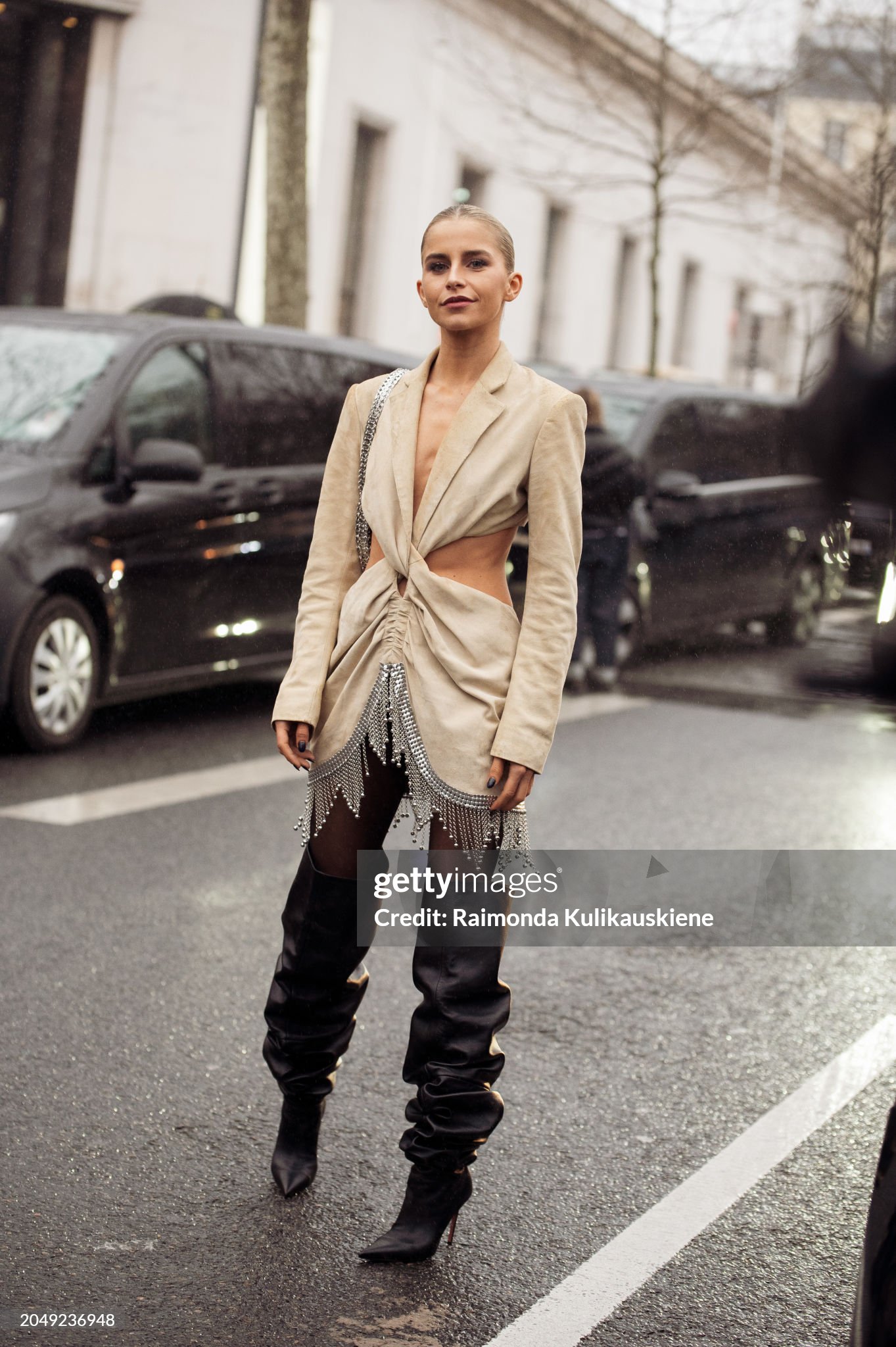 paris-france-caro-daur-wears-long-black-leather-boots-beige-mini-dress-with-cut-outs-and-metal.jpg