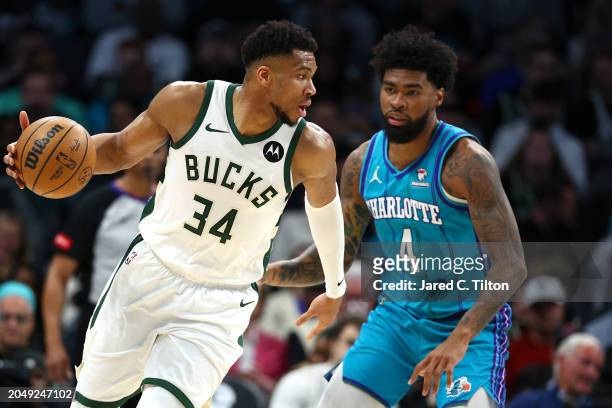 Giannis Antetokounmpo of the Milwaukee Bucks dribbles against Nick Richards of the Charlotte Hornets during the first half of the game at Spectrum...