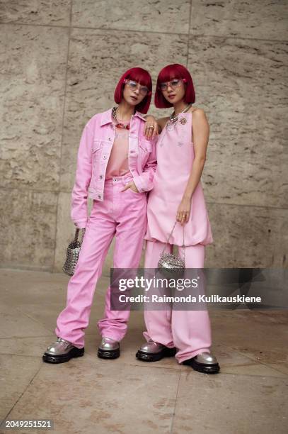 Aya Suzuki and Ami Suzuki aka Amiaya wear pink pants, pink top and silver bags outside Rabanne during the Womenswear Fall/Winter 2024/2025 as part of...