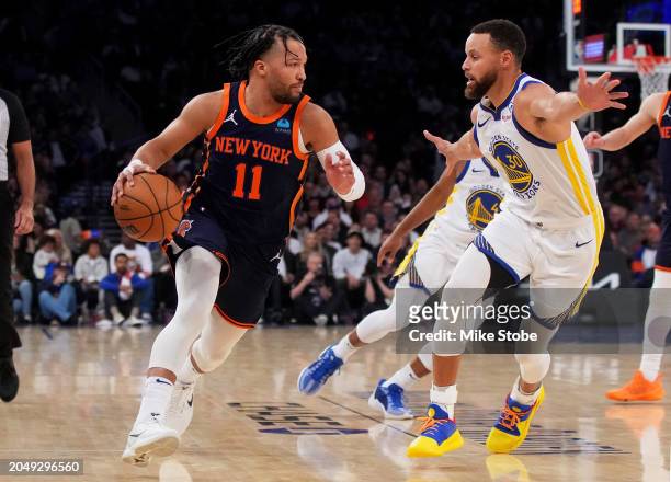 Jalen Brunson of the New York Knicks drives to the basket against Stephen Curry of the Golden State Warriors at Madison Square Garden on February 29,...