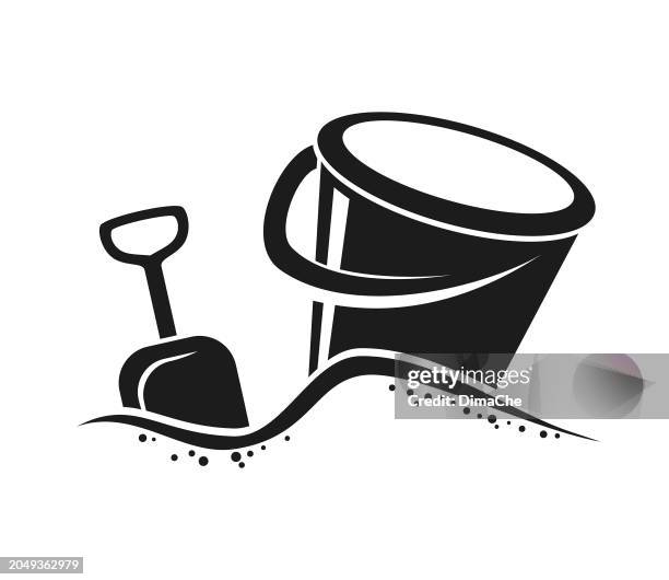 eimer mit griff und schaufel im sand - ausgeschnittene vektor-symbol-silhouette - sandkasten stock-grafiken, -clipart, -cartoons und -symbole