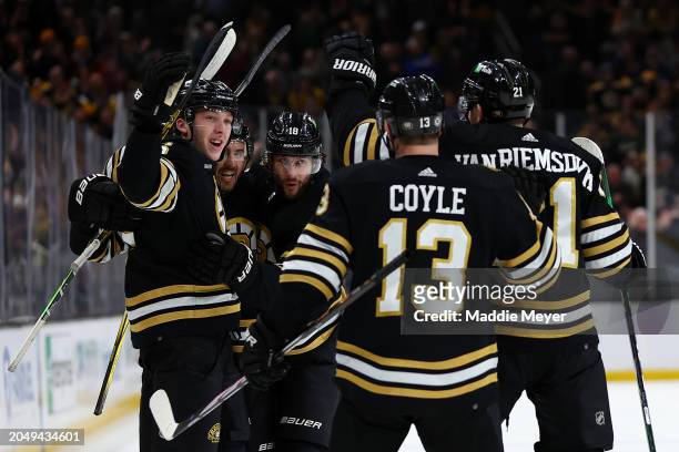 Mason Lohrei of the Boston Bruins celebrates with Kevin Shattenkirk, Pavel Zacha, Charlie Coyle, and James van Riemsdyk after scoring the game...
