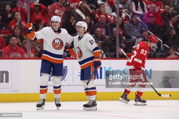 Mathew Barzal of the New York Islanders celebrates his third period goal with Noah Dobson next to Alex DeBrincat of the Detroit Red Wings at Little...