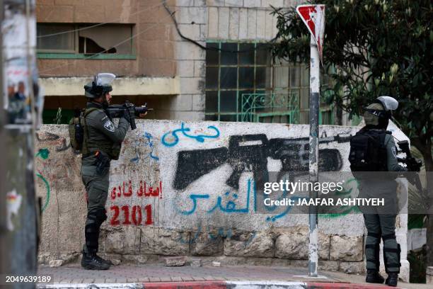 Israeli troops stand at attention during a raid on the Al-Amari refugee camp near Ramallah, in the occupied West Bank, on March 4, 2024.