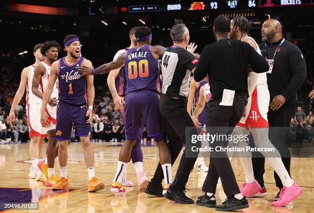 Devin Booker of the Phoenix Suns and Cam Whitmore of the Houston Rockets are separated after each receiving technical fouls during the second half of...