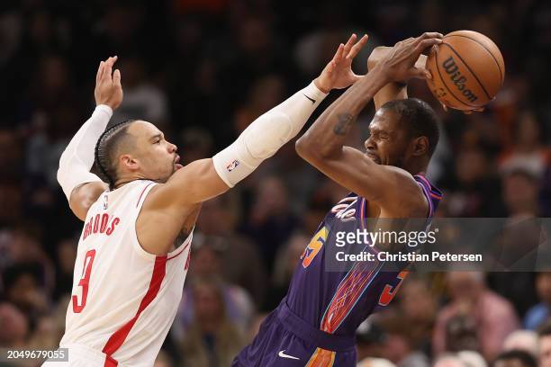 Kevin Durant of the Phoenix Suns attempts to pass the ball under pressure from Dillon Brooks of the Houston Rockets during the second half of the NBA...