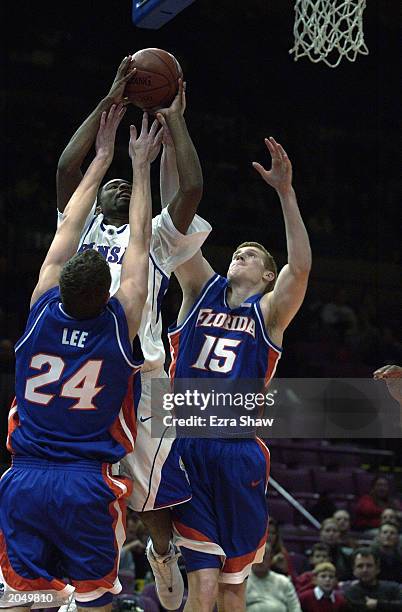 Keith Langford of Kansas of goes to the basket over David Lee and Matt Bonner of Florida during the Consolation Game of the Owens Corning Preseason...