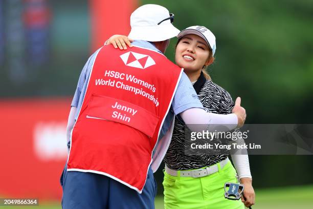 Ayaka Furue of Japan embraces the caddie of Jenny Shin of South Korea after finishing play on the 18th green during Day Two of the HSBC Women's World...