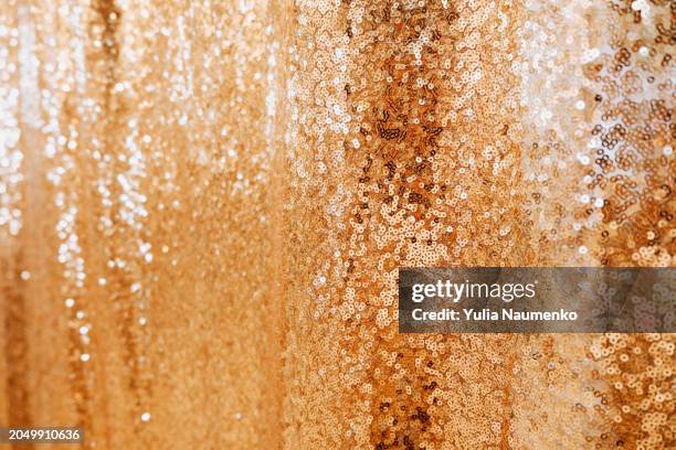 background with gold sequins. full frame, defocus. - gold sequin dress stock pictures, royalty-free photos & images