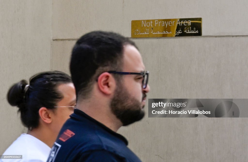 Samaha Signs Pedestrians walk by a