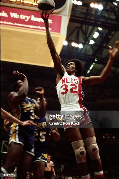 Julius Erving of the New York Nets soars to the basket against the Indiana Pacers during an ABA game at the Nassau Veterans Memorial Coliseum in 1974...