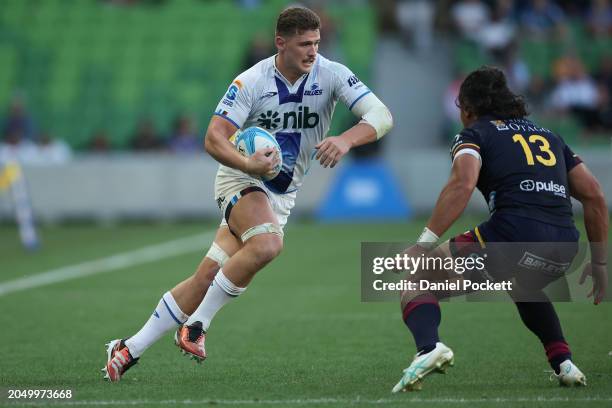 Dalton Papali'i of the Blues is tackled by during the round two Super Rugby Pacific match between Highlanders and Blues at AAMI Park, on March 01 in...