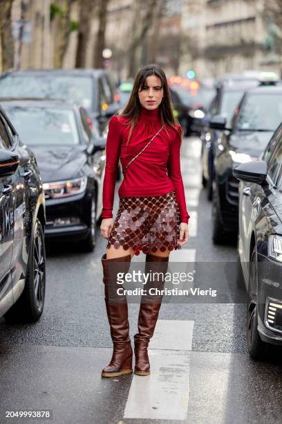 Nina Urgell Cloquell wears red long skirt, net skirt, brown over knees boots outside Paco Rabanne during the Womenswear Fall/Winter 2024/2025 as part...