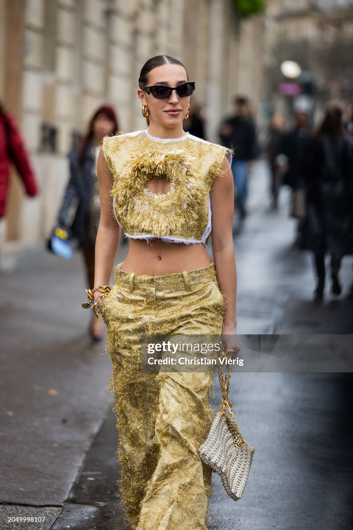 paris-france-ginevra-mavilla-wears-golden-cut-out-cropped-top-pants-bag-outside-paco-rabanne.jpg