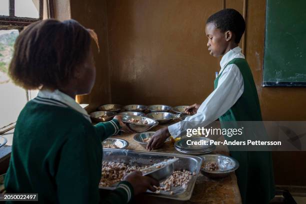 Students prepare a provided meal at Cwebeni Junior Secondary school on February 2 in Cwebeni, a rural village outside Port St Johns, South Africa....