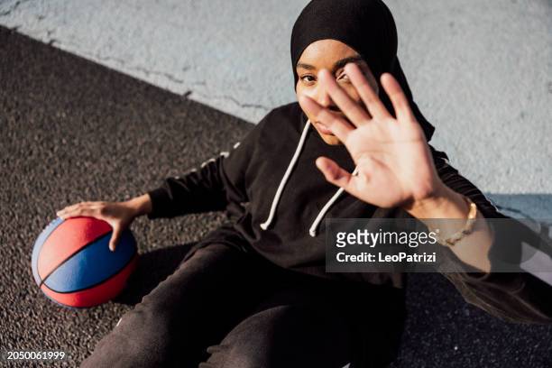 basketball player relaxing after training - sport determination stock pictures, royalty-free photos & images