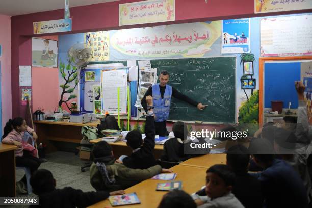 Ismail Wahba, director of the UNRWA Taif School in Rafah, teaches an english class in the library of the school housing displaced Palestinians, in...