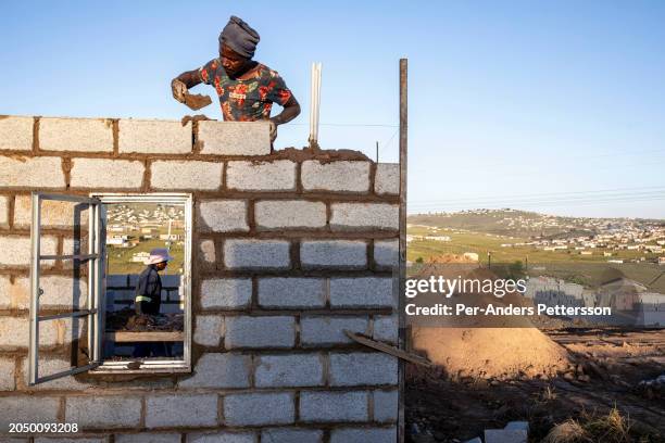 Construction workers build RDP , government provided houses that are free of charge on February 12 outside Mthatha, Eastern Cape Province, South...