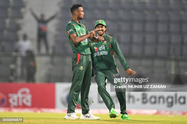 Bangladesh's Shoriful Islam celebrates with teammate after taking the wicket of Sri Lanka's Avishka Fernando during the first Twenty20 international...