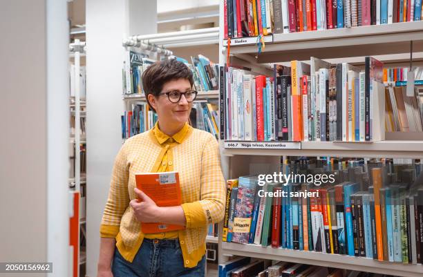 woman portrait in the public library - librarian stock pictures, royalty-free photos & images