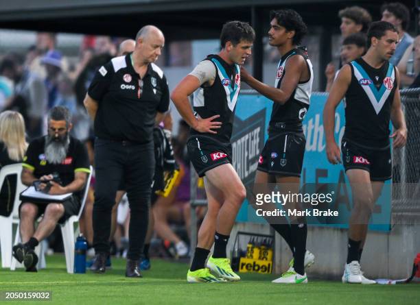 Zak Butters of the Power leave the ground after hurting his ankle during the 2024 AFL Community Series match between Port Adelaide Power and...