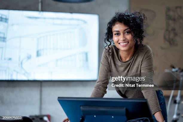 every function and feature you want in construction designs with eco-design. portrait of a project manager or designer in a modern office is working her construction project design for client. - designer industriale foto e immagini stock