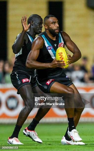 Esava Ratugolea of the Power marks in front of Aliir Aliir of the Power during the 2024 AFL Community Series match between Port Adelaide Power and...