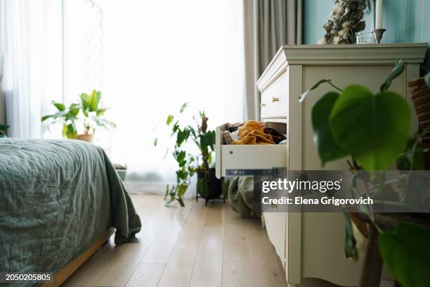 side view of opened dresser in modern bedroom in green tones - chest of drawers stock pictures, royalty-free photos & images