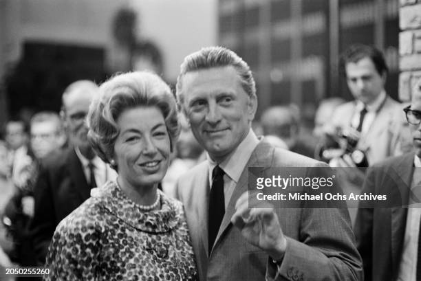German-born American film producer Anne Buydens and her husband, American actor Kirk Douglas, attend the US premiere of 'La Dolce Vita', held at the...