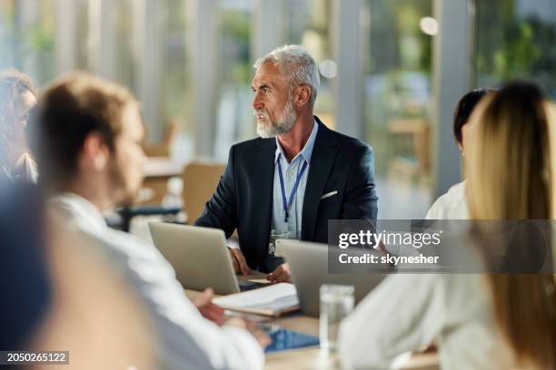 senior businessman talking to medical experts on a meeting in hospital. - meeting the right person stock pictures, royalty-free photos & images