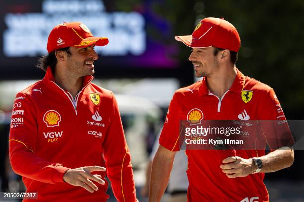 Charles Leclerc of Monaco and Scuderia Ferrari and Carlos Sainz of Spain and Scuderia Ferrari walk together in the paddock during qualifying ahead of...