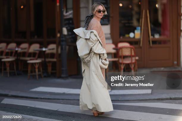 Karin Teigl seen wearing Loewe gold / brown tortoise sunglasses, Dior beige / black striped pattern silk scarf, H&M Studios beige glitter studs...