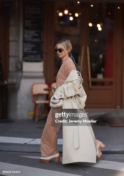 Karin Teigl seen wearing Loewe gold / brown tortoise sunglasses, Dior beige / black striped pattern silk scarf, H&M Studios beige glitter studs...