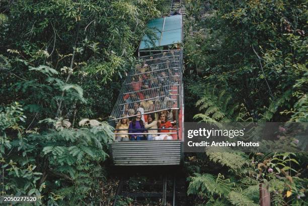 Tourists are protected by a steel frame roof as they ride the Scenic Railway, at Scenic World in Katoomba, Blue Mountains, New South Wales,...