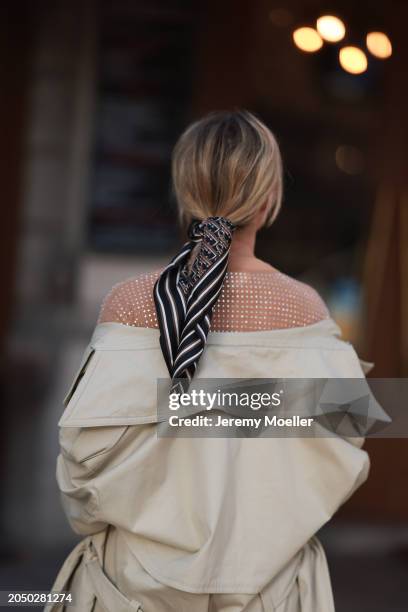 Karin Teigl seen wearing Dior beige / black striped pattern silk scarf, H&M Studios beige glitter studs pattern oversized t-shirt and H&M Studios...