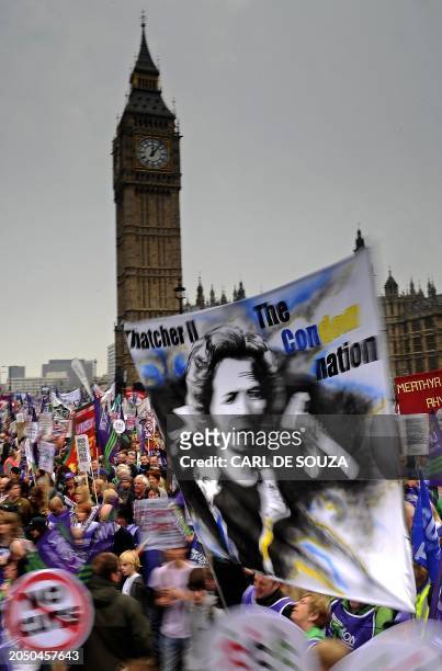Demonstrators walk past the Houses of Parliament during a Trade Union Congress march in London on March 26, 2011. Hundreds of thousands of people...