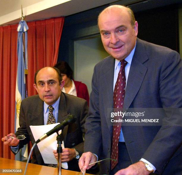 Domingo Cavallo, the Argentine minister of the economy, enters a conference hall with Jose Maria Farre , the secretary of public income, in Buenos...