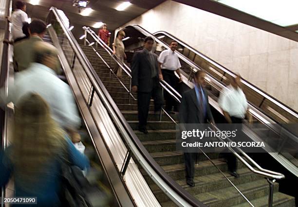 Workers use both escalator and regular stairs in one of Rio de Janeiro's largest buildings, which consumes a total of 4 megawatts of energy monthly,...