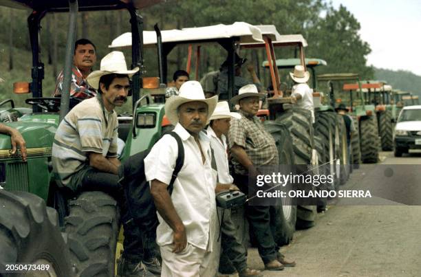 Farmers and cattle dealers of Olancho, Honduras, block the road to the capital with their tractors 06 March 2001 demanding from the Carlos Flores...