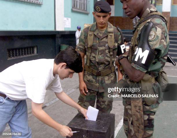 Ecuadoran army soldiers guard a ballot box as a Guayas province resident votes 23 January on a referendum demanding more political and economical...