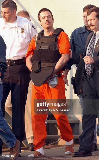 Bombing suspect Eric Robert Rudolph is escorted from the Cherokee County Jail for a hearing in federal court in Asheville June 2, 2003 in Murphy,...