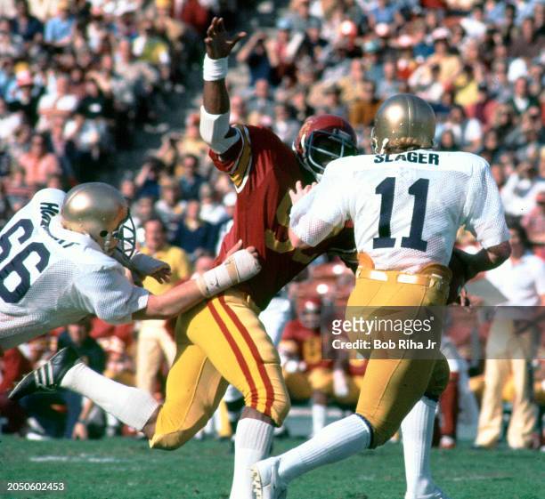 Notre Dame Quarterback Rick Slager under heavy pass rush from University of Southern California Linebacker Rod Martin during USC- Notre Dame game...