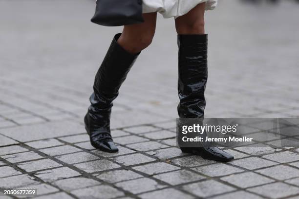 Cherifa Akili seen wearing Ganni white balloon short dress, Fendi black leather bag and Khaite black structure leather heeled high boots / overknee...