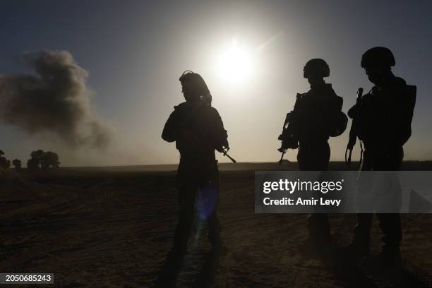 Soldiers with the Israel Defense Forces stand with their weapons on March 4, 2024 in southern Israel near the border with Gaza. Over the weekend, the...
